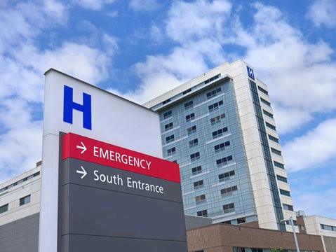 Hospital building exterior with an emergency entrance sign